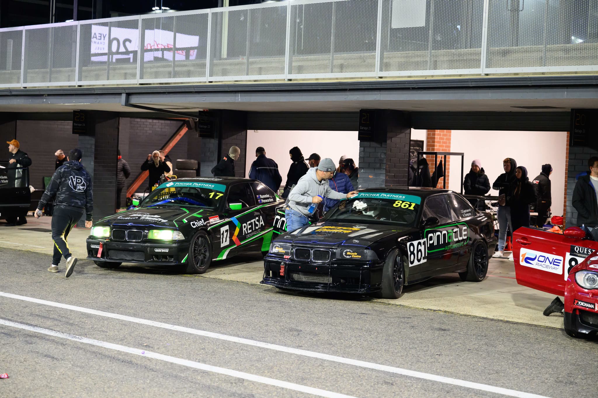 Project E36 Racing Cars in pit lane at night